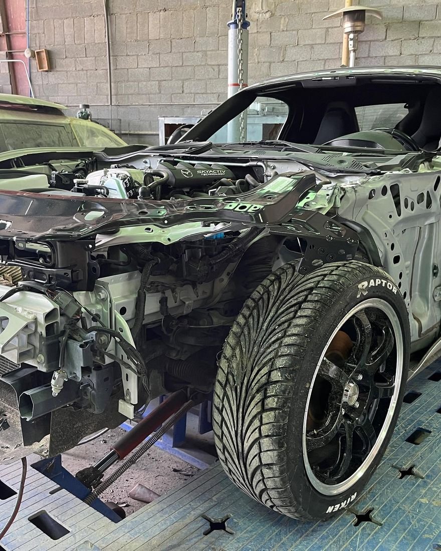 Mazda MX-5 on the frame machine with the front end removed for structural repair