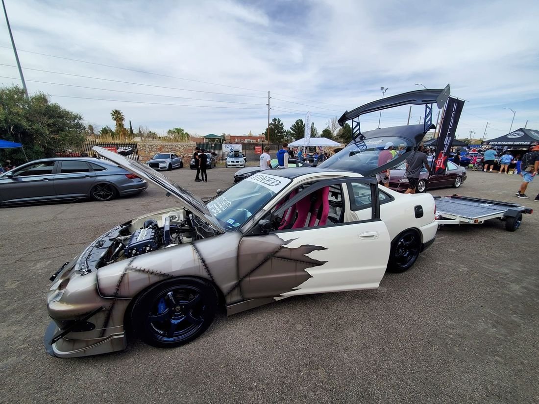 White Acura Integra with a torn-metal rust effect painted on the front fender and door